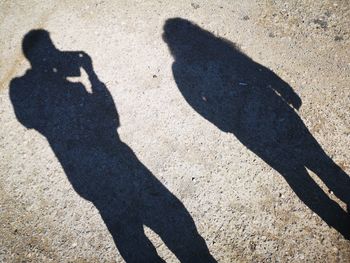 Shadow of couple on road