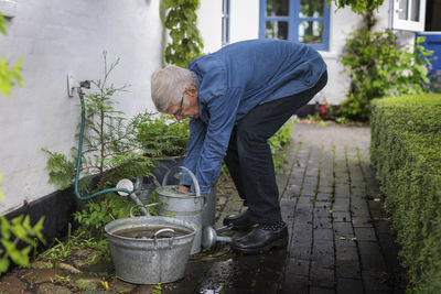 Man filling watering can