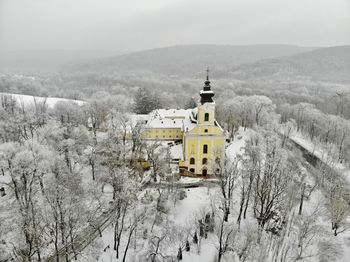 High angle view of trees and buildings against sky during winter