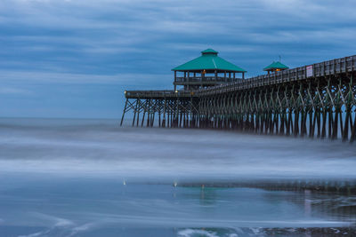 Pier over sea against sky