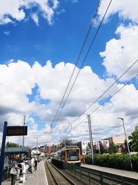 Cars on street in city against sky