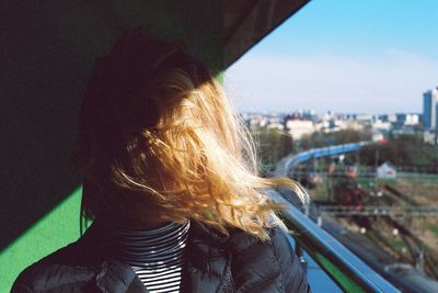 Close-up of woman with hair on face against sky