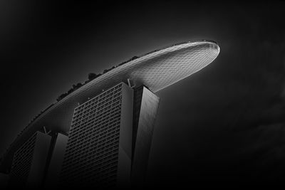 Low angle view of modern building against sky at night