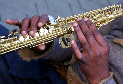 Midsection of man playing guitar