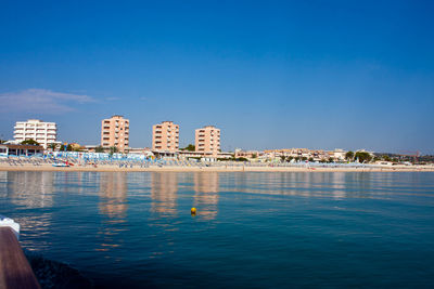 View of built structures against clear blue sky