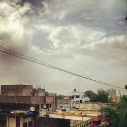 Low angle view of buildings against cloudy sky