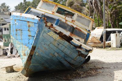 Abandoned boat on shore