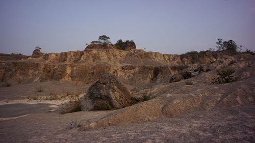 Rock formations on landscape against clear sky