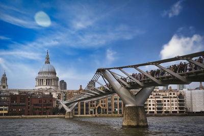 View of bridge over river against buildings