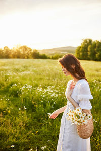 Side view of woman standing on field