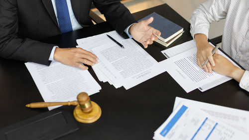 Midsection of business colleagues working on table