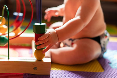 Midsection of boy playing with toy