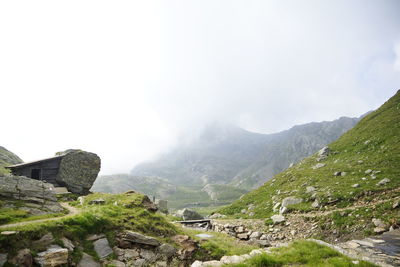 Scenic view of mountains and houses against sky