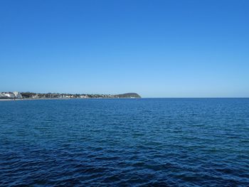 Scenic view of sea against clear blue sky