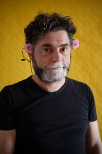 Portrait of mature man wearing mask against gray background