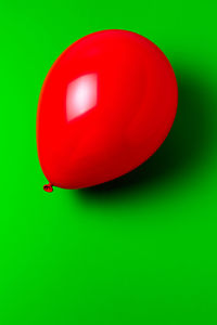 Close-up of red balloons against green background