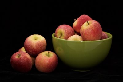 Close-up of apples on table against black background