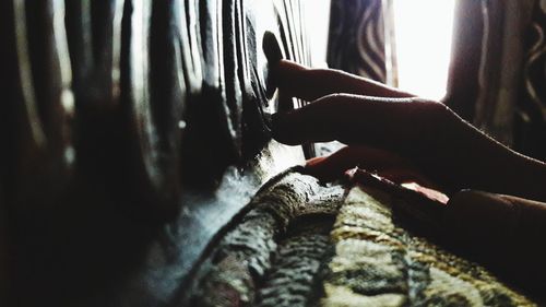 Close-up of woman holding hands at home