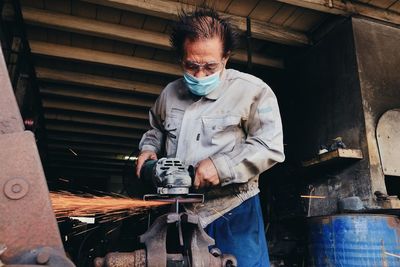 Man working on metal grate
