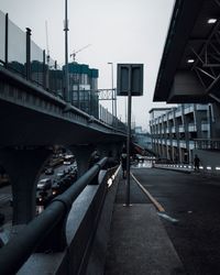 Bridge in city against sky