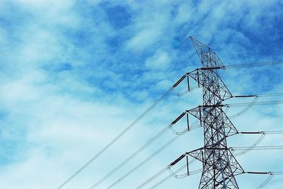 Low angle view of electricity pylon against sky