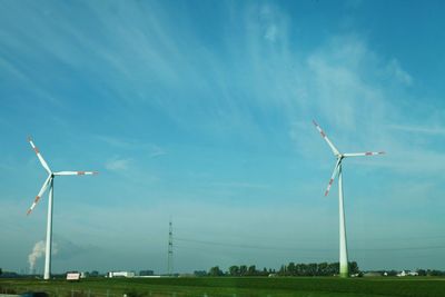 Windmill on field against sky