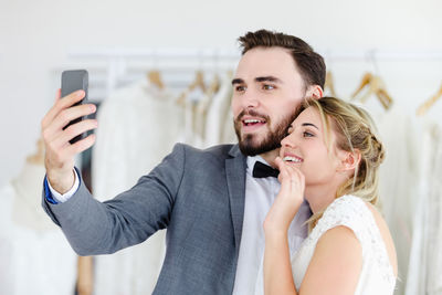 Portrait of smiling young woman using mobile phone