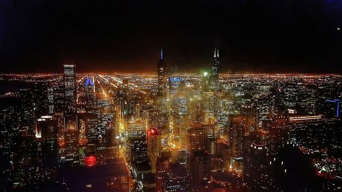 High angle view of illuminated city buildings at night