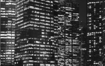 Low angle view of modern buildings in city at night