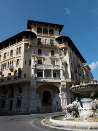 Low angle view of historic building against blue sky