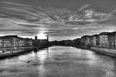 River amidst buildings in city against sky