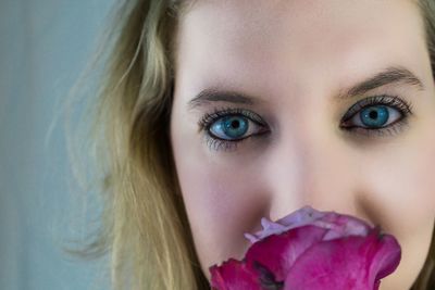 Close-up portrait of beautiful woman with flower