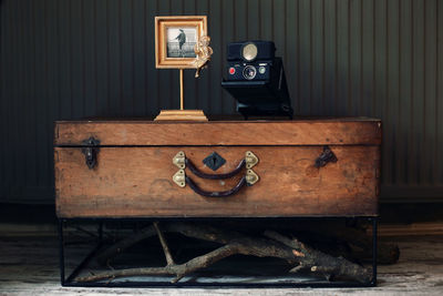 Old telephone booth on table against wall at home