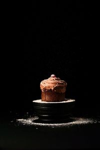 Close-up of chocolate cake against black background