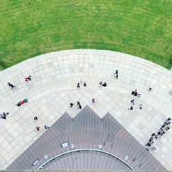 High angle view of people walking on pathway by lawn