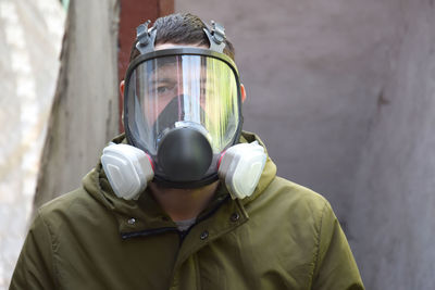 Rear view of man wearing gas mask