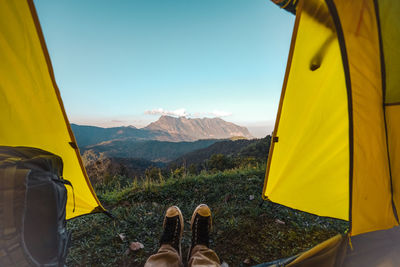 Low section of person relaxing in tent