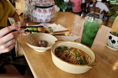 Midsection of man having food at restaurant table