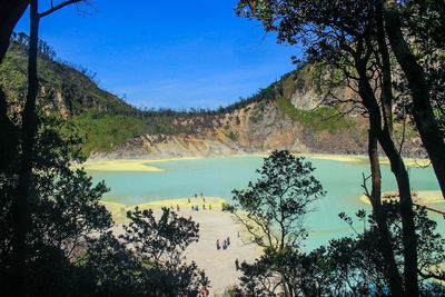 Scenic view of lake and trees against blue sky