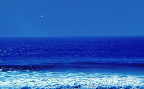 Scenic view of sea against blue sky