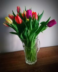 Close-up of tulips in vase on table at home