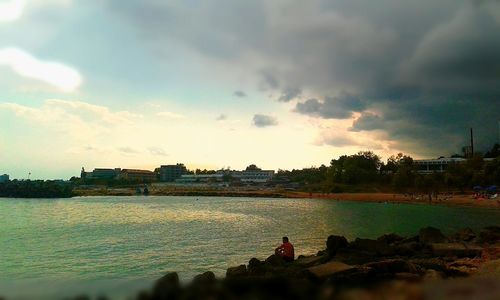 Silhouette of woman against cloudy sky