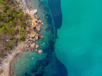 High angle view of rocks on sea shore