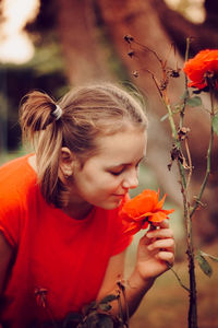 Close-up of girl holding flowering plant