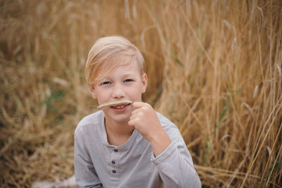 Portrait of  boy blowing dandelion