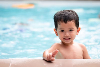 Shirtless boy enjoying at swimming pool