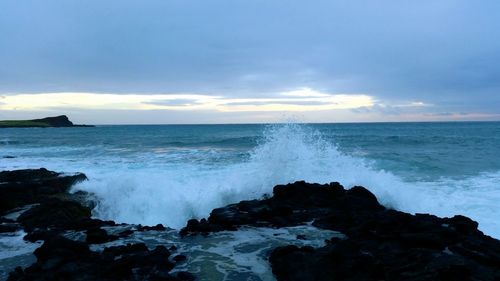 Scenic view of sea against cloudy sky