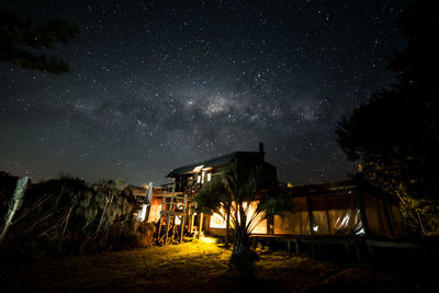 Illuminated built structure against sky at night