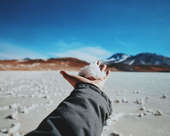 Person holding snow on palm