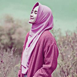 Portrait of a beautiful young woman in field